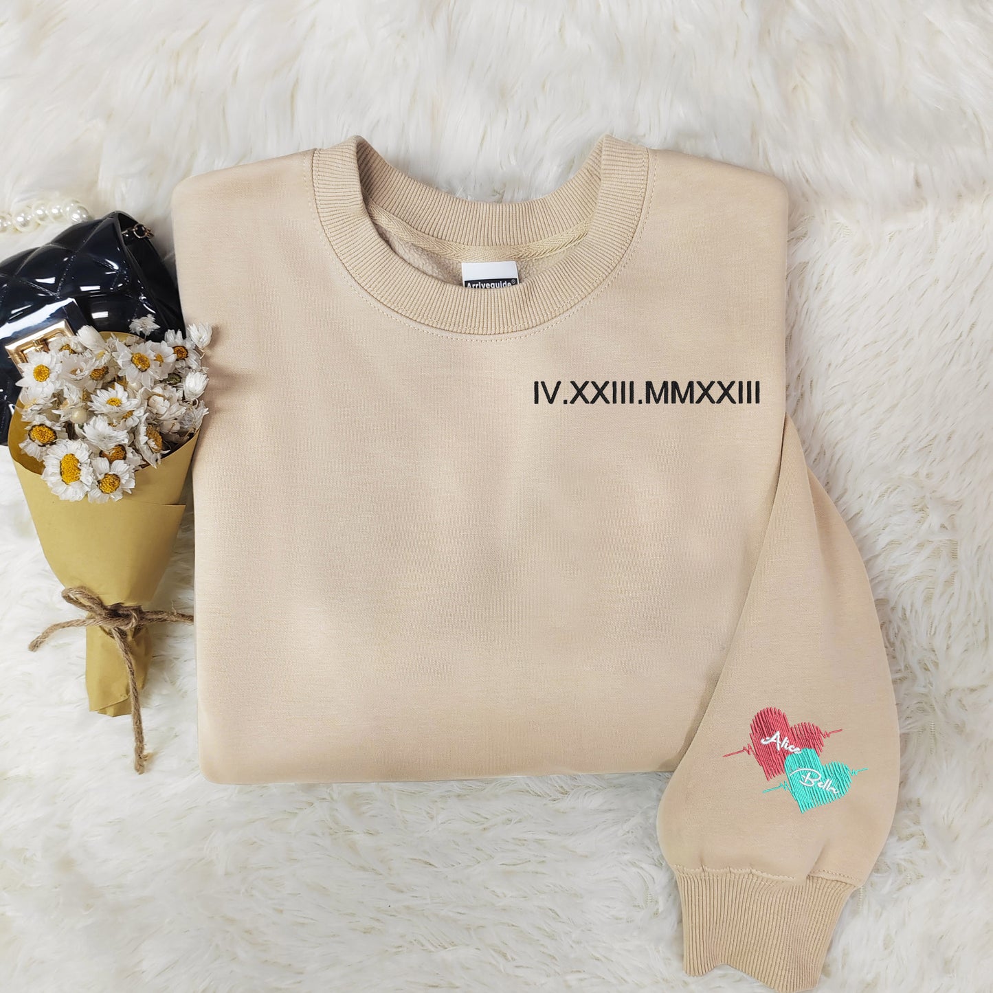 Customized Roman numeral embroidered sweatshirts for couples, with the couple’s names embroidered on the cuffs.
