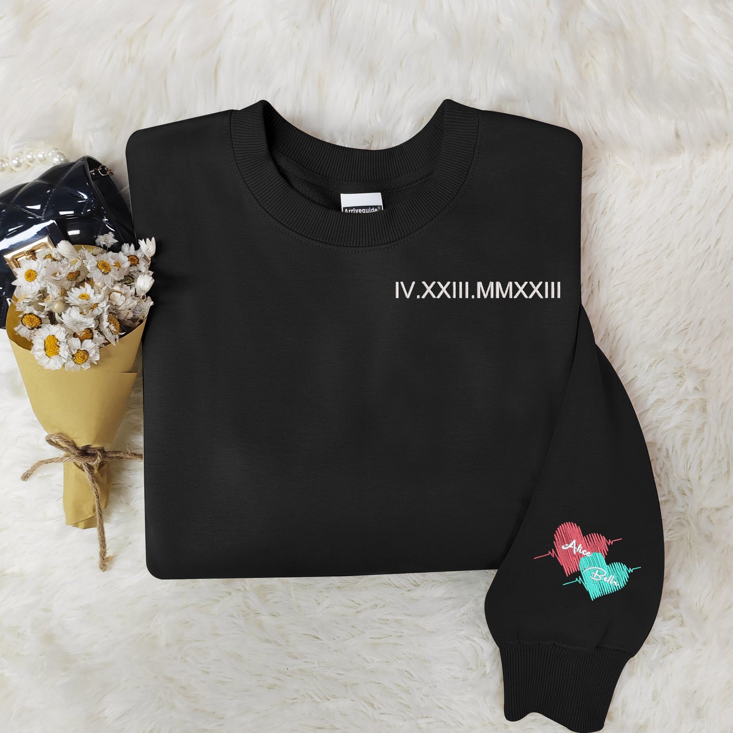 Customized Roman numeral embroidered sweatshirts for couples, with the couple’s names embroidered on the cuffs.